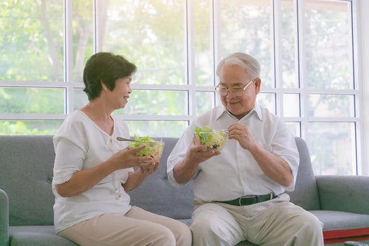 Elderly couple savoring a fresh and vibrant salad together